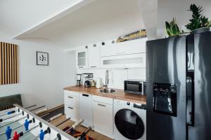 a kitchen with a refrigerator and a sink at The Garage No.6 in Vienna