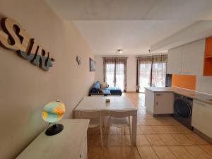 a kitchen and living room with a table and a table at Buen Camino El Cotillo in El Cotillo