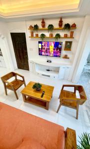 a living room with a couch and a tv at Explore Iloilo - Accessible Apartment in Iloilo City