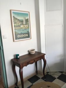 a wooden table in a room with a picture on the wall at La Loge de Marguerite in Champtoceaux
