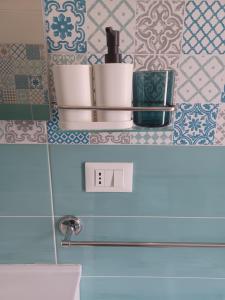 a shelf above a toilet in a bathroom with tiles at due stanzulelle sul mare B&B in Salerno +76 photos