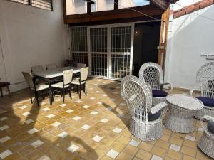 a patio with a table and chairs on a tiled floor at CASA PATRICIAS in Godoy Cruz