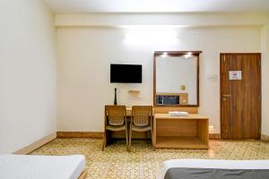 um quarto com uma mesa e duas cadeiras e um espelho em Hotel Dreamy Sunshine em kolkata