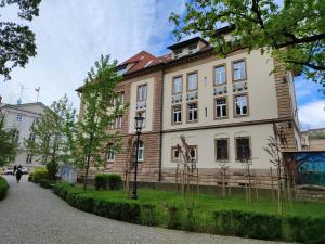 a large white building with a red roof at Apartament Jak w banku in Kłodzko