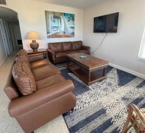 a living room with a couch and a coffee table at 763 North Shore Downstairs Apts in Anna Maria