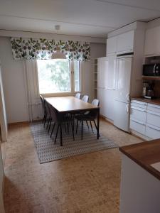 a kitchen with a table and chairs in a kitchen at Asuntos-1 in Lahti