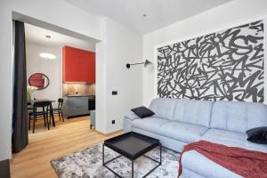 a living room with a couch and a black and white wall at Sea Moreto Apartment 2 in Burgas City +2 photos