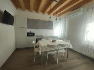 a kitchen with a table and chairs in a room at Parsifal House in Chioggia