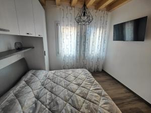 a bedroom with a large bed and a window at Parsifal House in Chioggia