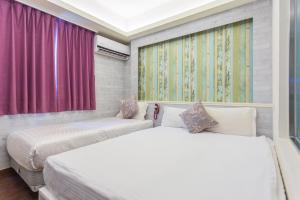 Postel nebo postele na pokoji v ubytování Newrise Hotel