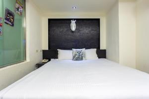 Postel nebo postele na pokoji v ubytování Newrise Hotel