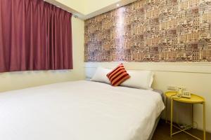 Postel nebo postele na pokoji v ubytování Newrise Hotel