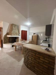 a kitchen with a brick counter top in a room at Appartamento Sud Sardegna, Cagliari Elesar'sHome in Capoterra
