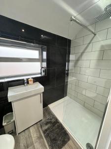 a bathroom with a shower and a sink at Elegant Large Room in Beckenham