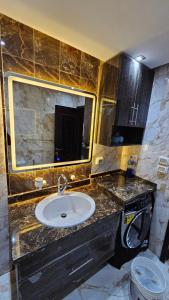 a bathroom with a sink and a mirror at shiraton Cairo Airport appartement in Cairo