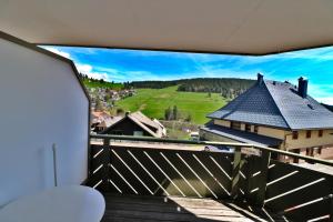 a balcony with stairs and a view of a house at Apartment 03 - Ferienresidenz Roseneck, mit Schwimmbad in Todtnauberg bei Feldberg in Todtnauberg