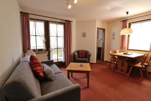 a living room with a couch and a table at Apartment 03 - Ferienresidenz Roseneck, mit Schwimmbad in Todtnauberg bei Feldberg in Todtnauberg