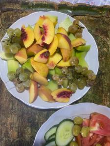 two plates of fruit on top of a table at Rupa Guest House in Theth