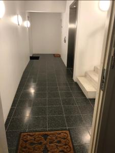 an empty hallway with a tile floor and stairs at Canal view In City in Copenhagen