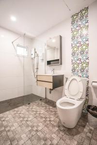 a bathroom with a toilet and a sink and a shower at Blue cafe Apartments in Chiang Mai