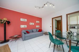 a living room with a couch and a glass table at Le Mandarine Apartments - Superior Apartment in Udine