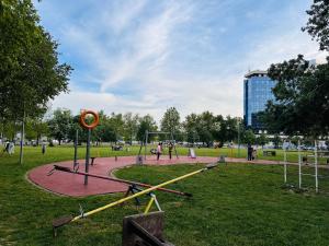 a playground in a park with people playing at Blok in Sajmište