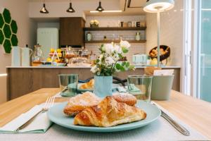 una mesa con un plato de cruasanes. en Etna Cottage Charming Bed and breakfast en Nicolosi