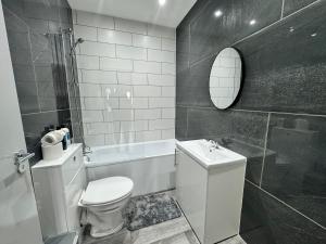 a white bathroom with a toilet and a shower at Cosy Budget Room in Beckenham