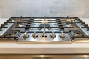 a stove top oven with a bunch of burners on it at Skyview 2 Bedroom Penthouse in Los Angeles