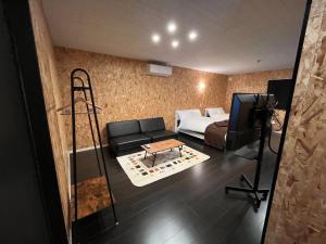 a room with a couch and a bed and a television at Sasebo - Cottage - Vacation STAY 71282v in Sasebo