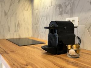 a toaster sitting on top of a counter with a cup at Tonea's Houses in Himare