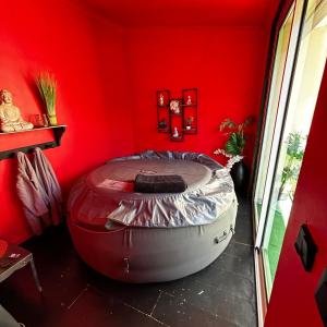 Milhaud的住宿－Loft 80m2 avec sauna, spa, table de massage et billard，红色的房间,设有大型红色墙