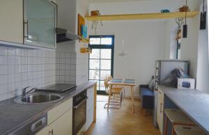 a kitchen with a sink and a counter top at FEWO mit Sauna & Gartenblick in Neustadt in Sachsen