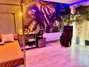 a room with a bed and a wall with plants at Apartment Aura Spa Wesel in Wesel