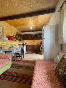 a kitchen with a table and a dining room at Origjina Farm in Përmet +14 photos