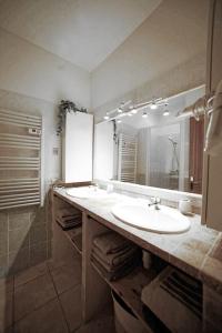 łazienka z 2 umywalkami i dużym lustrem w obiekcie Maison de village Les amandiers w mieście Baudinard