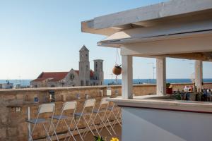 a group of chairs sitting on a balcony with a view at S. Martin Hotel in Giovinazzo +72 photos
