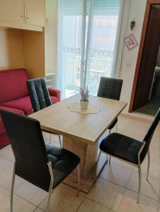 a wooden table and chairs in a room at Viale Aurora in Bibione