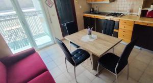 a kitchen with a table and chairs in a kitchen at Viale Aurora in Bibione