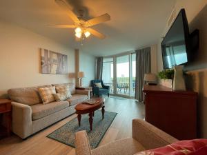 a living room with a couch and a table at The Horizon at 77th in Myrtle Beach