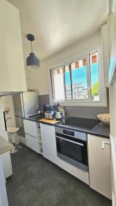 a kitchen with a sink and a stove top oven at Studio tout confort gare de Lyon - possibilité parking in Paris