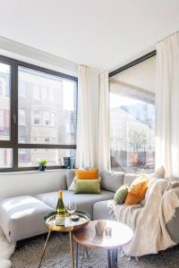 a living room with a couch and a large window at Deluxe apartment suite with terrace in Antwerp