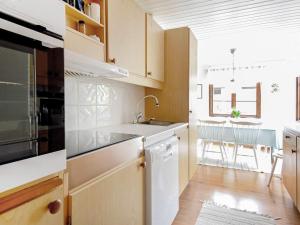 a kitchen with a sink and a table with chairs at 7 person holiday home in Bovallstrand in Bovallstrand