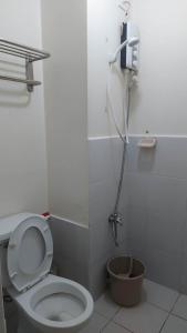 a bathroom with a toilet and a shower at Zafreen Staycation/CONDOTEL in Manila