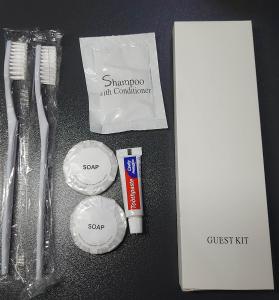 a table with toothbrushes toothpaste and a box ofoss kit at Zafreen Staycation/CONDOTEL in Manila