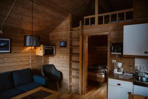 a living room with a blue couch in a wooden room at Vinje Camping in Geiranger