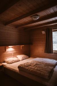 a bedroom with a bed in a wooden room at Vinje Camping in Geiranger