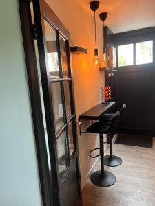 a room with a table and a stool next to a door at De Overkant in Voorst