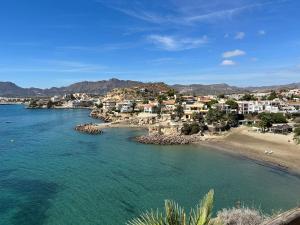a view of a beach with houses and the ocean at The three bedrooms Casa Barta - 300m from the beach with a beatiful see view from the terrace and private parking in San Juan de los Terreros