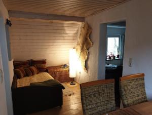 a bedroom with a bed and a table and chairs at Unser Obervolkacher Ferienhaus - Hideaway & Gartenoase mit Wohlfühlflair und Herz für Hunde in Volkach